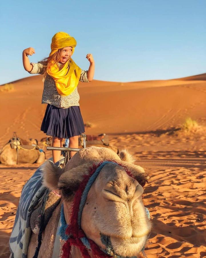 Sahara Majestic Luxury Camp Hotel Merzouga Exterior photo A child riding a camel